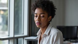 Person practicing mindful work at a desk, focused.